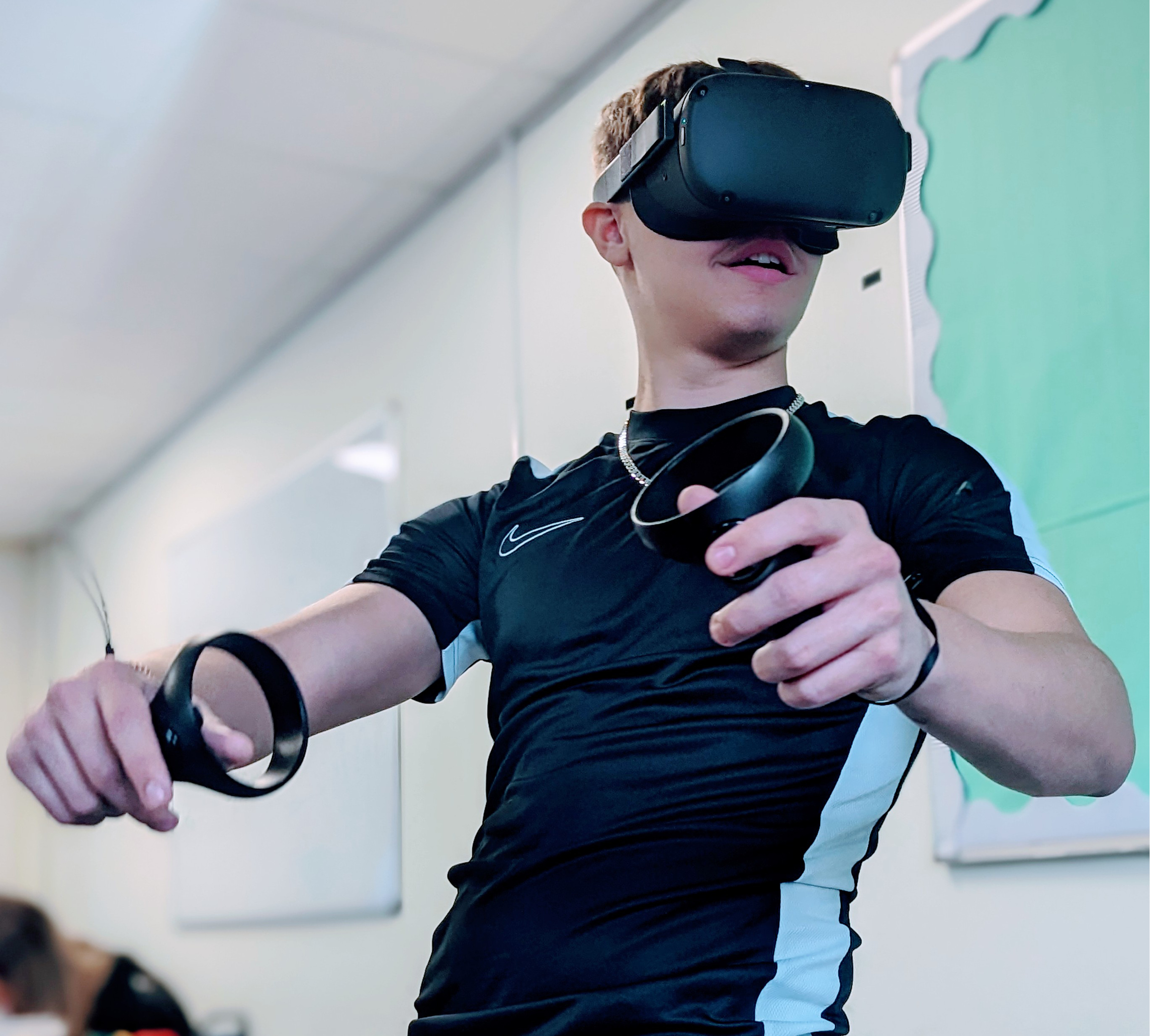 Student with VR headset and hand held controllers