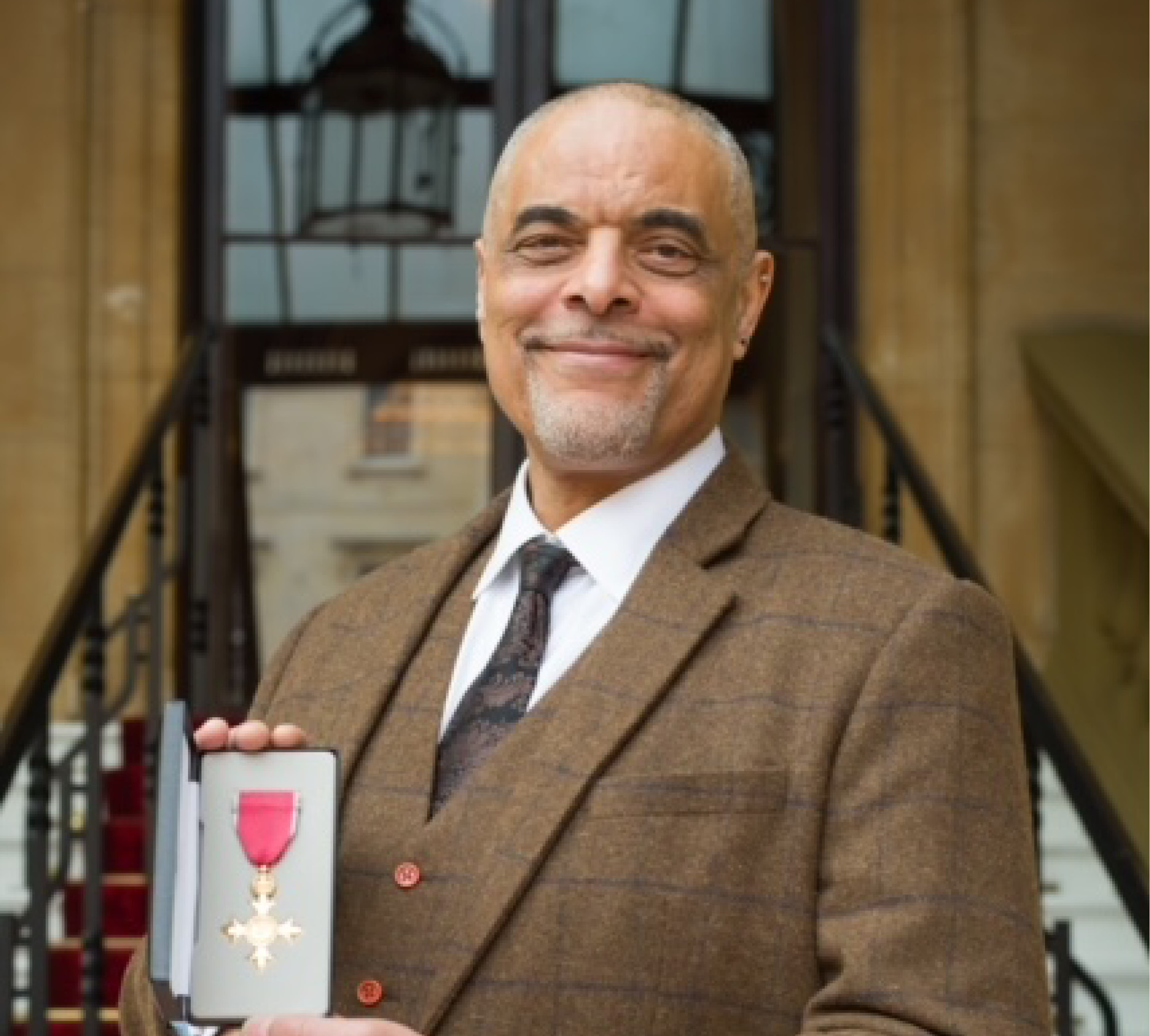 Portrait of College Principal receiving OBE